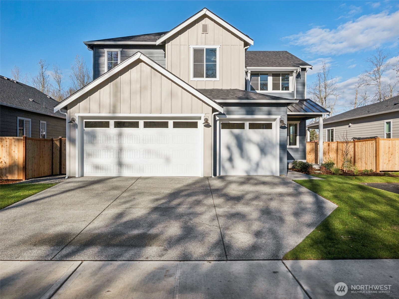 a view of a house with a yard and garage