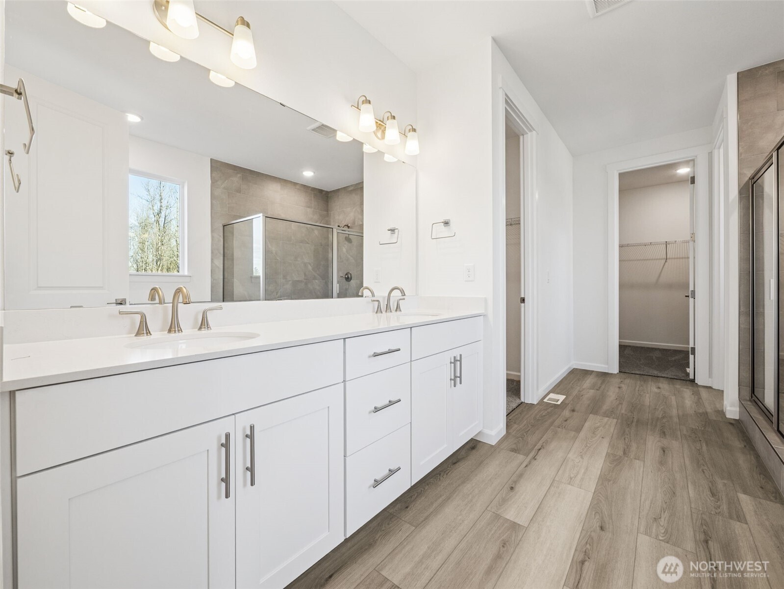 1132 Tanner Avenue, Unit 111 Buckley, WA 98321 - Photo 11 of 17 a spacious bathroom with a double vanity sink and mirror