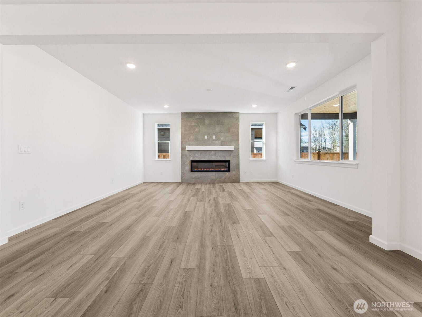 1132 Tanner Avenue, Unit 111 Buckley, WA 98321 - Photo 6 of 17 wooden floor in an empty room with a window