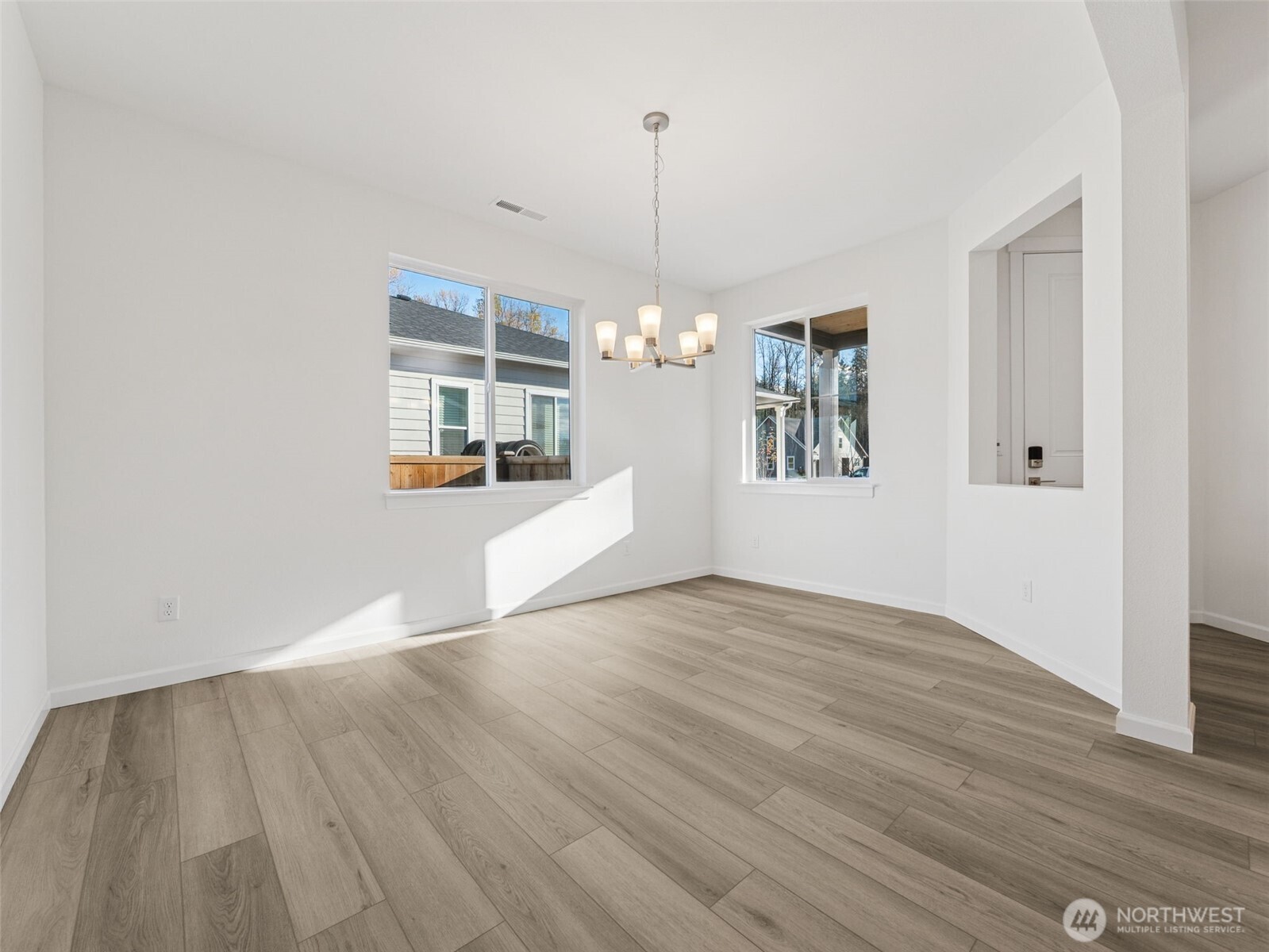 1132 Tanner Avenue, Unit 111 Buckley, WA 98321 - Photo 7 of 17 a view of a room with wooden floor and white walls