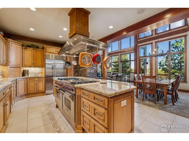 a kitchen with a stove a refrigerator and a dining table