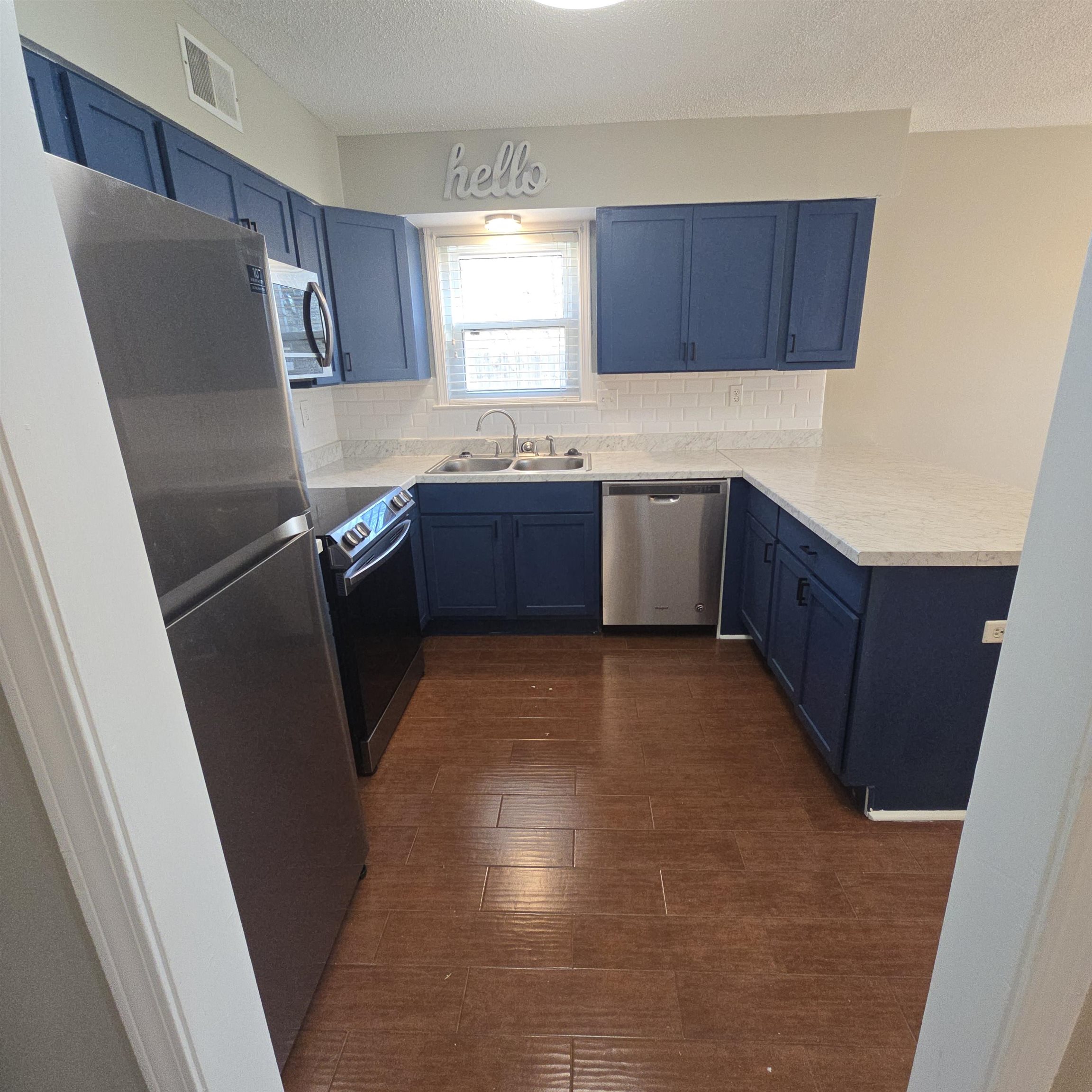 2317 Belin Drive Memphis, TN 38133 - Photo 9 of 14 a kitchen with stainless steel appliances granite countertop a refrigerator a sink a stove a microwave a sink and a counter