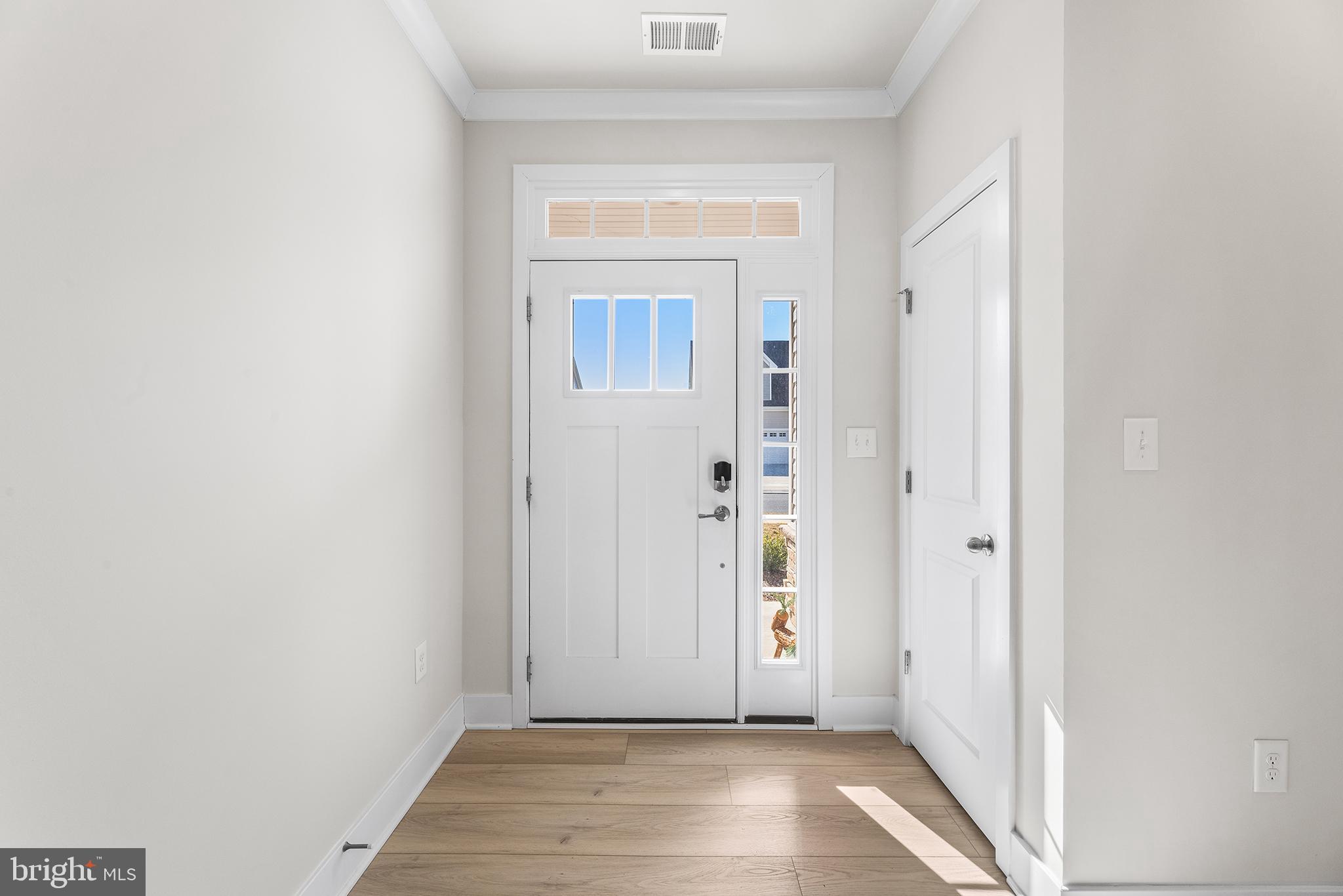 29255 Baker Island Road Lewes, DE 19958 - Photo 3 of 56 a view of a hallway with wooden floor