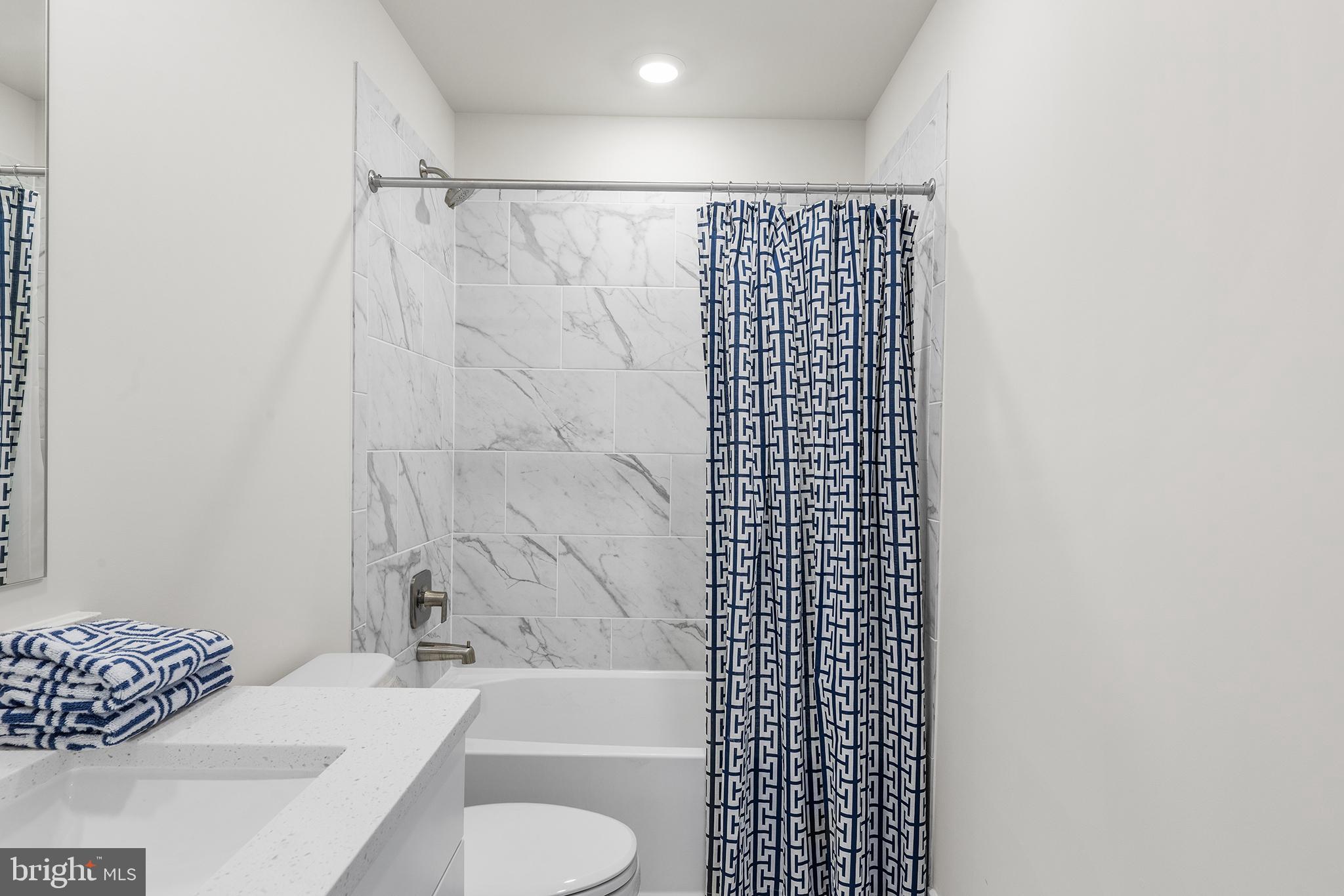 29255 Baker Island Road Lewes, DE 19958 - Photo 47 of 56 a bathroom with a shower toilet and sink