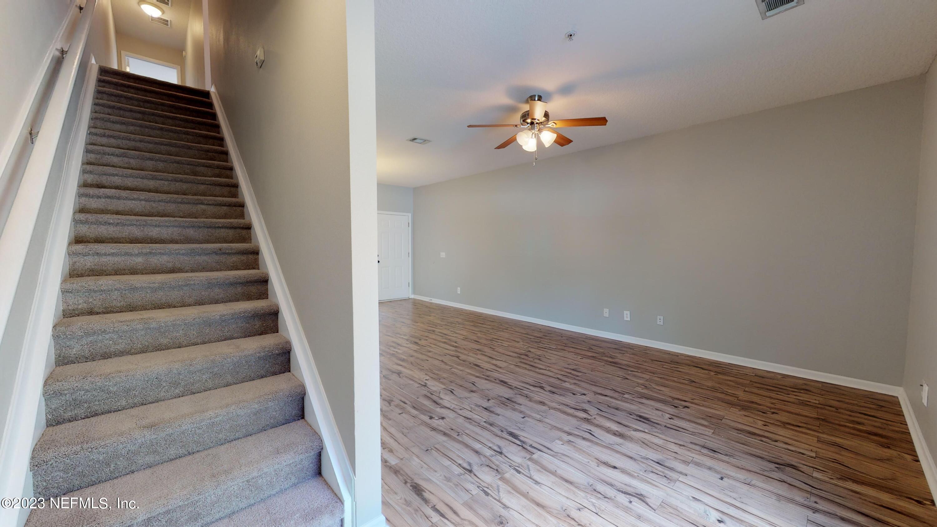 168 Leese Drive St. Johns, FL 32259 - Photo 12 of 25 wooden floor in an empty room with staircase