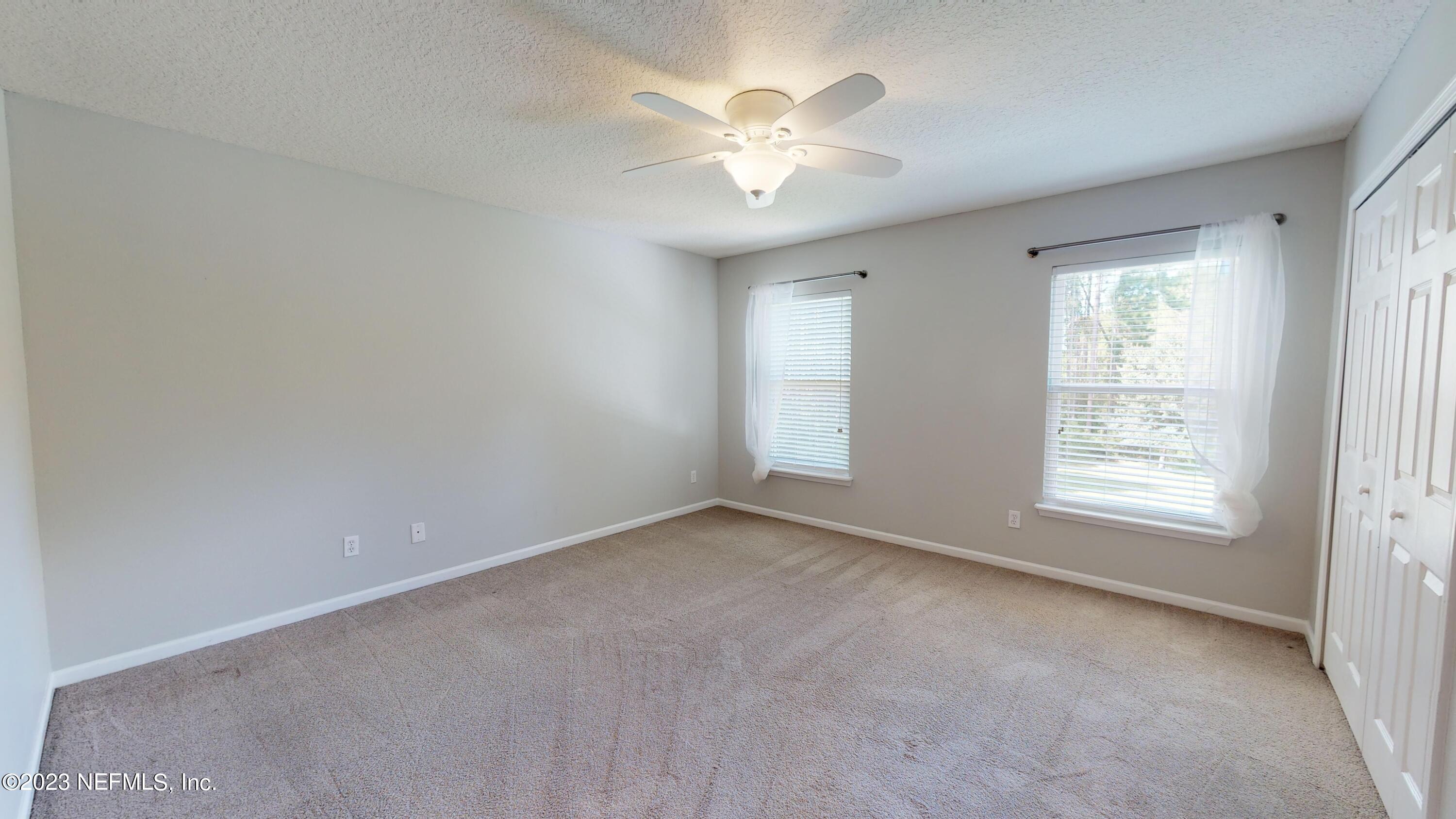168 Leese Drive St. Johns, FL 32259 - Photo 13 of 25 an empty room with windows and chandelier fan