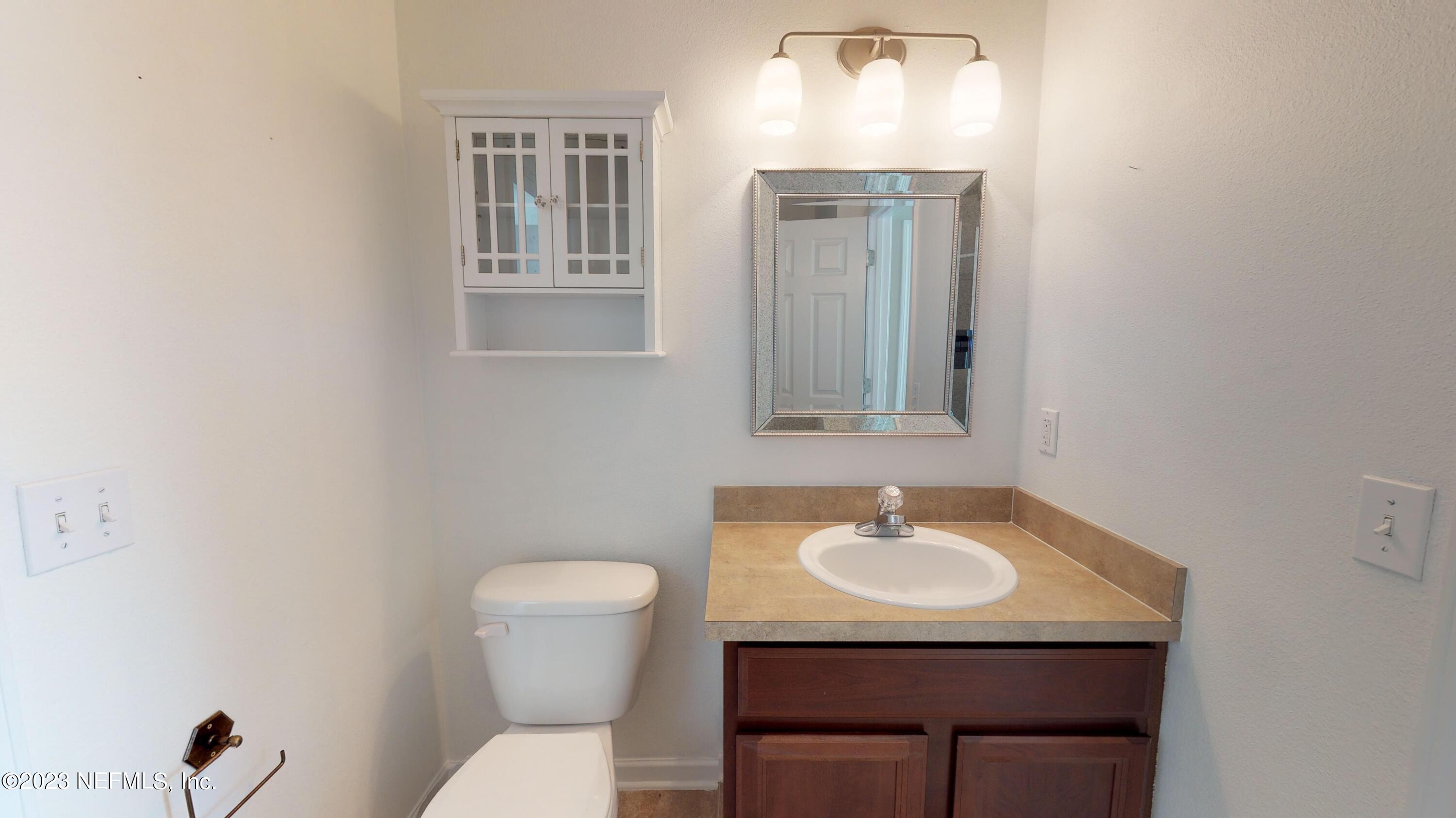 168 Leese Drive St. Johns, FL 32259 - Photo 16 of 25 a bathroom with a toilet sink and mirror