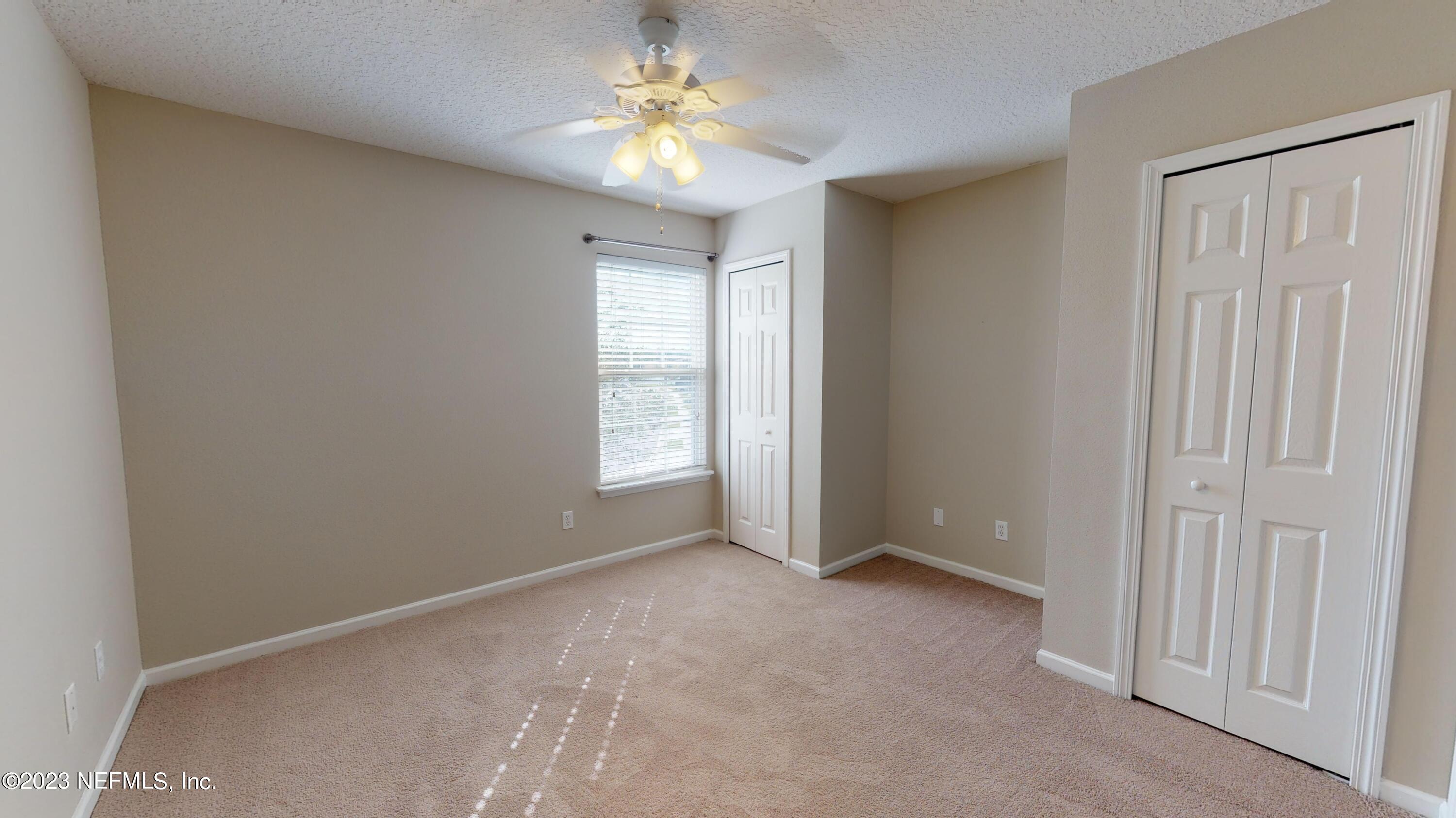 168 Leese Drive St. Johns, FL 32259 - Photo 17 of 25 an empty room with a window and a ceiling fan