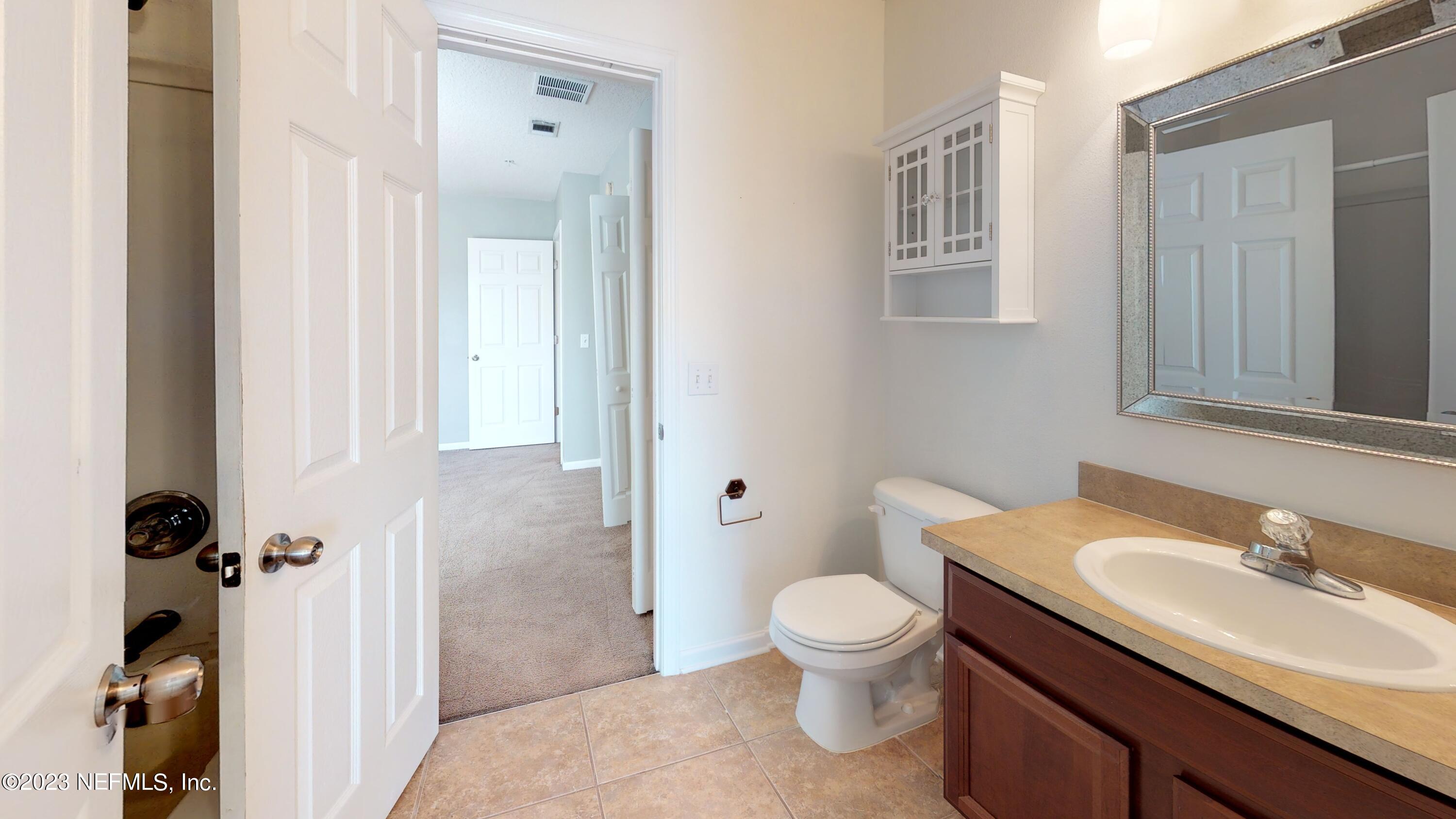 168 Leese Drive St. Johns, FL 32259 - Photo 21 of 25 a bathroom with a granite countertop toilet sink and mirror