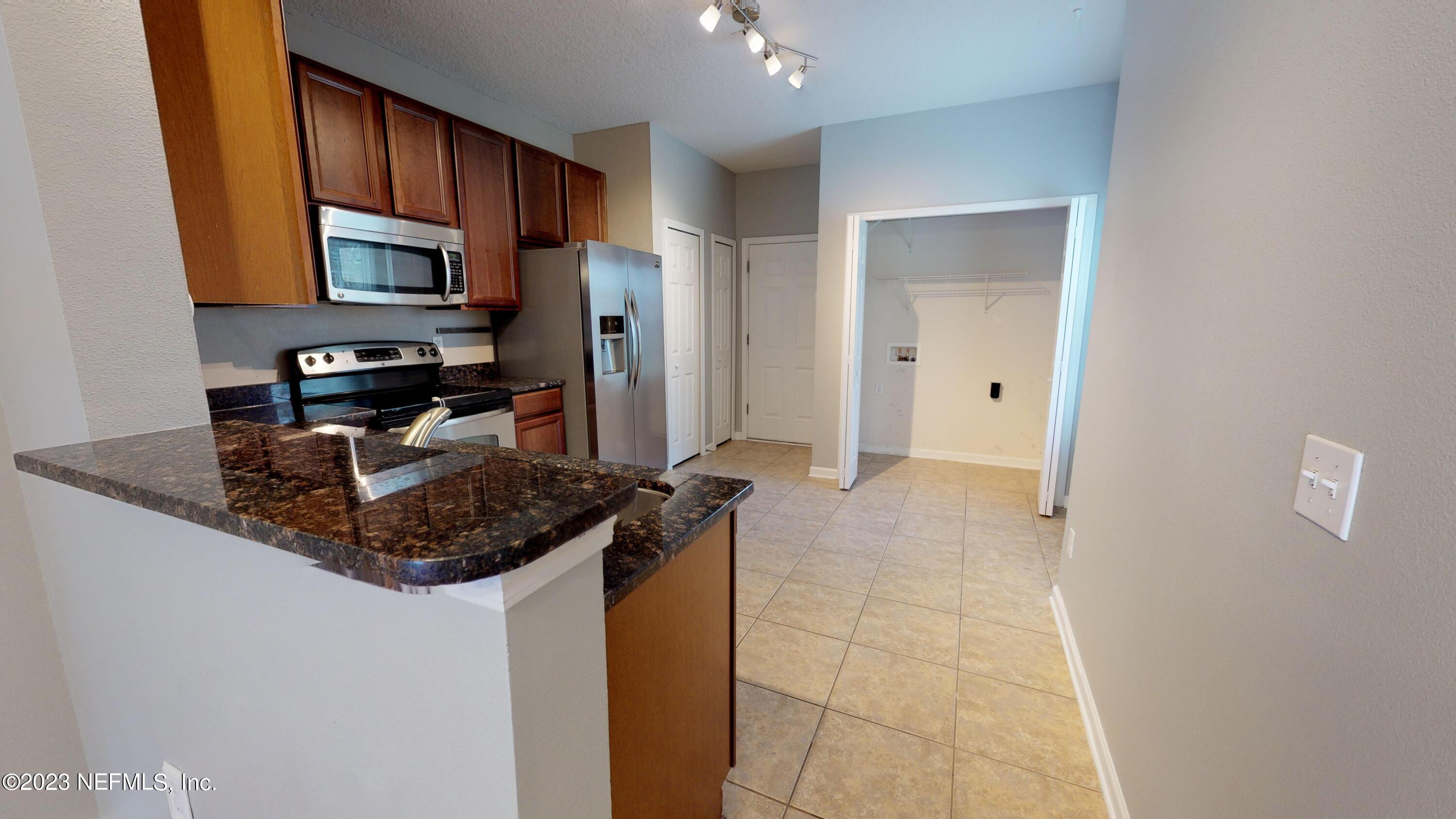 168 Leese Drive St. Johns, FL 32259 - Photo 3 of 25 a kitchen with stainless steel appliances granite countertop a sink stove and refrigerator