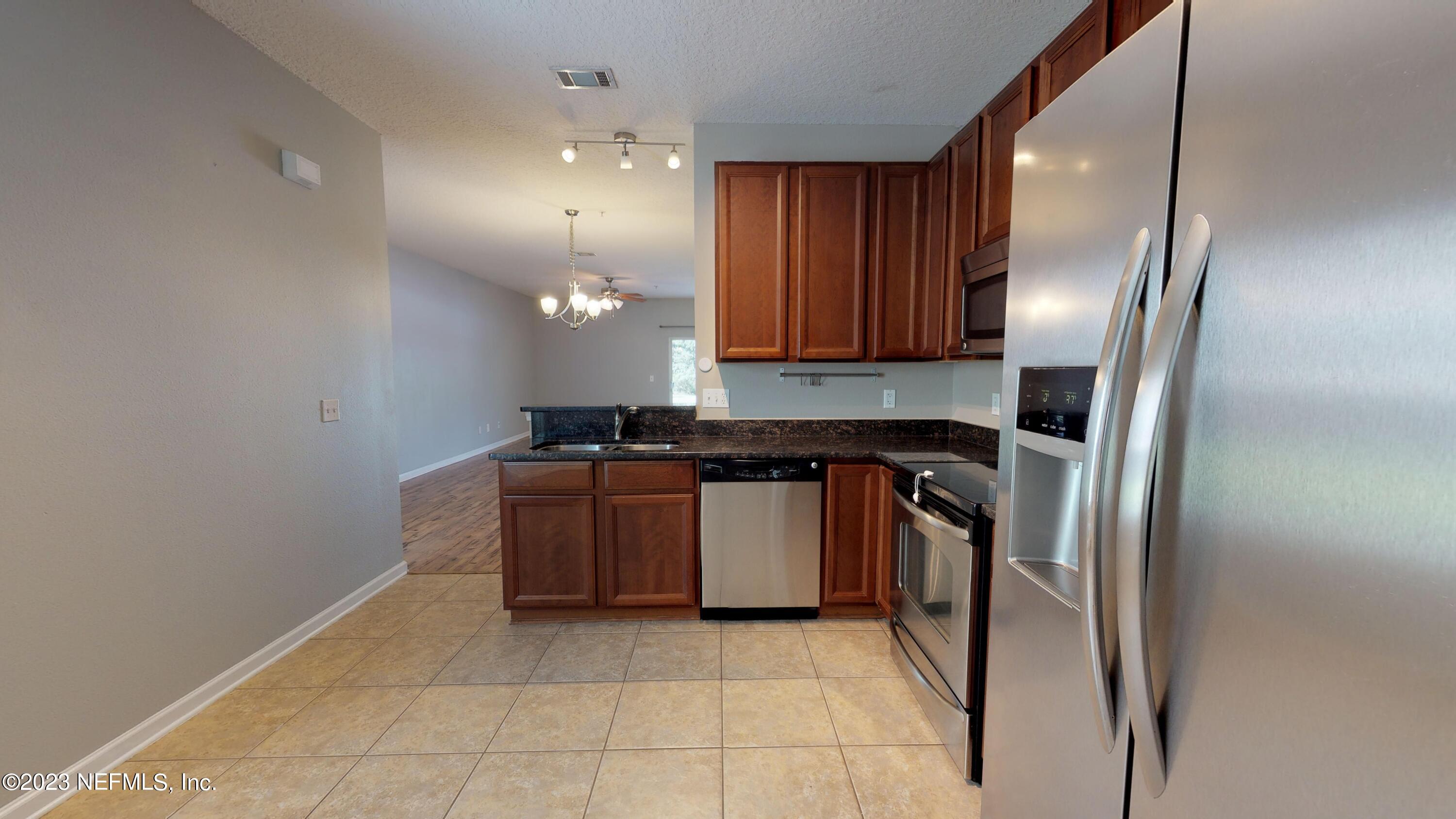 168 Leese Drive St. Johns, FL 32259 - Photo 7 of 25 a kitchen with stainless steel appliances granite countertop a sink a stove and a refrigerator