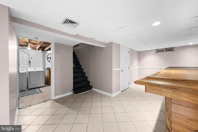 a view of a kitchen with furniture and an empty room