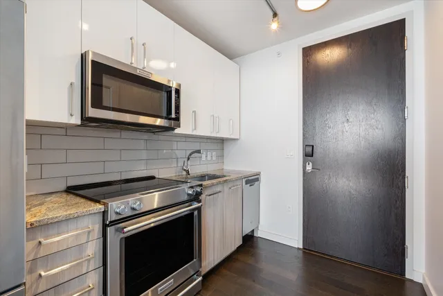 a kitchen with a stove microwave and sink