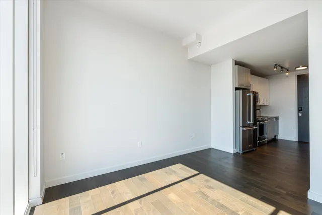a view of a kitchen with a sink and a refrigerator