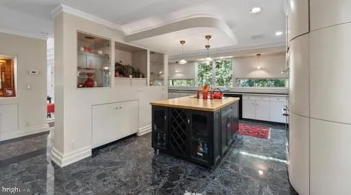 a view of a house with brick walls and flower plants