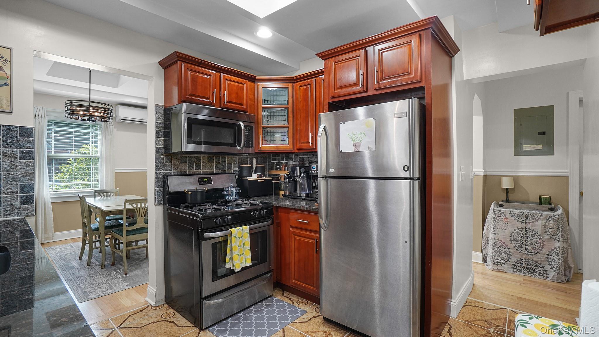 172-17 Amelia Road Queens, NY 11434 - Photo 8 of 18 a kitchen with stainless steel appliances granite countertop a refrigerator a stove a sink a dining table and chairs