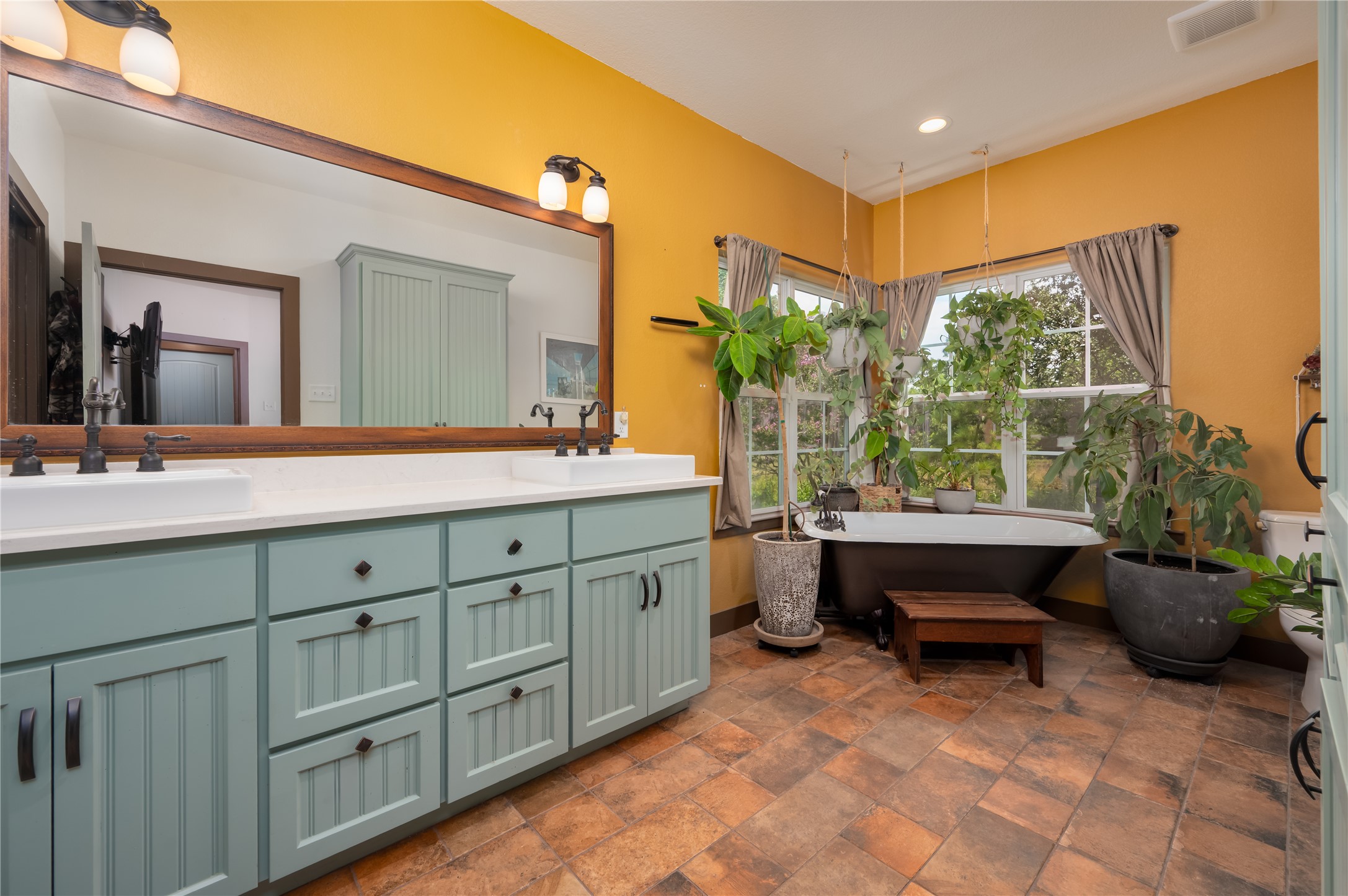 270 Dry Creek Road Manor, TX 78653 - Photo 10 of 40 A spacious primary bathroom boasts a freestanding tub, ample natural light, and a double vanity.