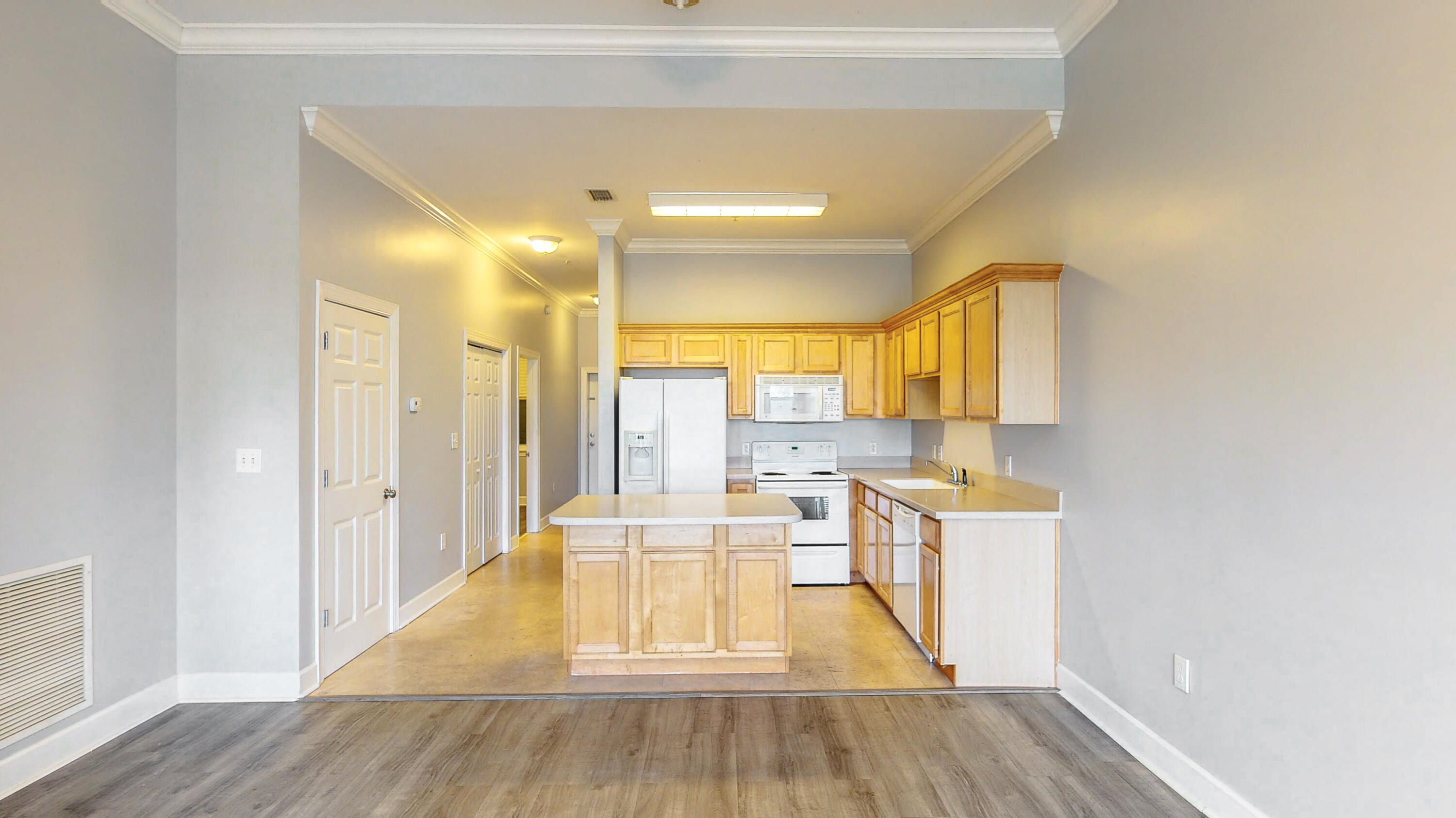 231 Somerset Bridge Road, Unit 1408 Santa Rosa Beach, FL 32459 - Photo 12 of 25 a view of a kitchen with kitchen island wooden floors and stainless steel appliances