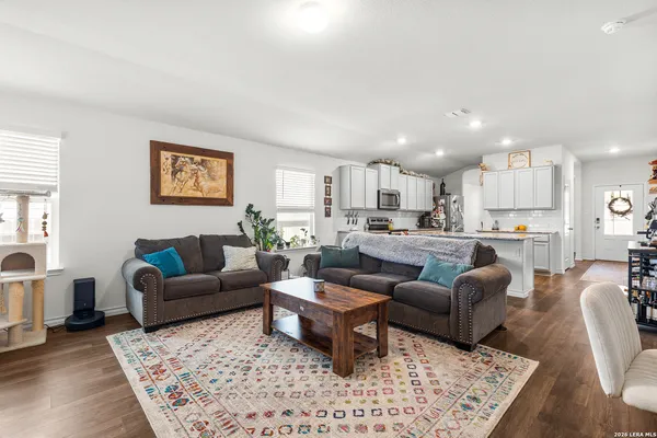 a living room with furniture kitchen view and a table