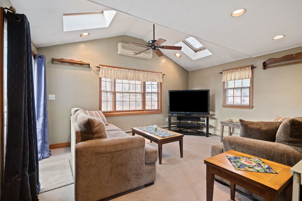 37 Glendale Street Maynard, MA 01754 - Photo 8 of 33 a living room with furniture a flat screen tv and a window