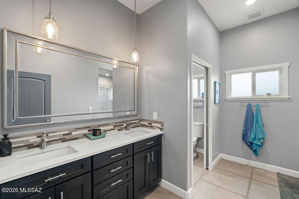 16276 East Empire View Road Vail, AZ 85641 - Photo 25 of 51 a bathroom with a sink a mirror and a shower