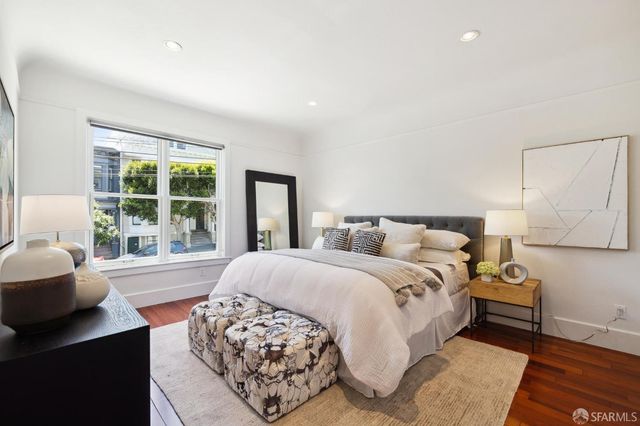 a spacious bedroom with a bed and a couch