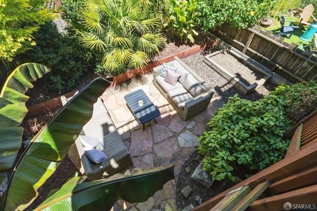 an aerial view of a house with a garden and plants