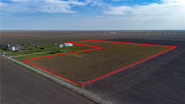 a view of a tennis ground with large trees