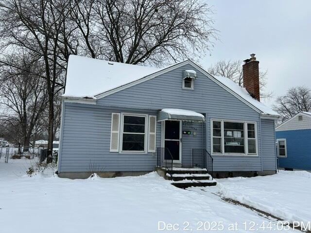 a view of a house with a snow in the yard
