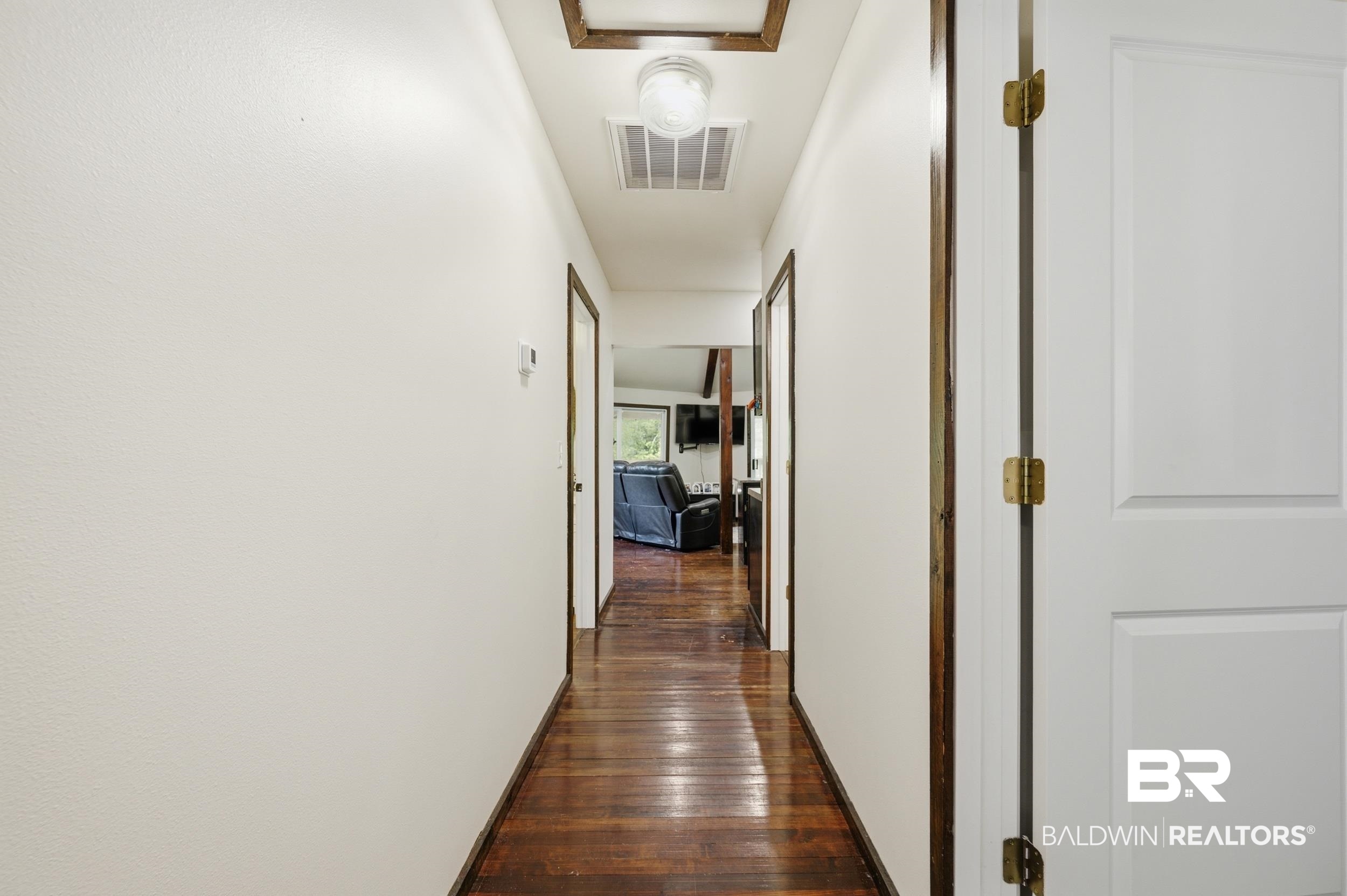 42080 Bayou Road Bay Minette, AL 36507 - Photo 27 of 43 Hallway featuring wood-finish flooring, white walls, and a recessed ceiling light fixture