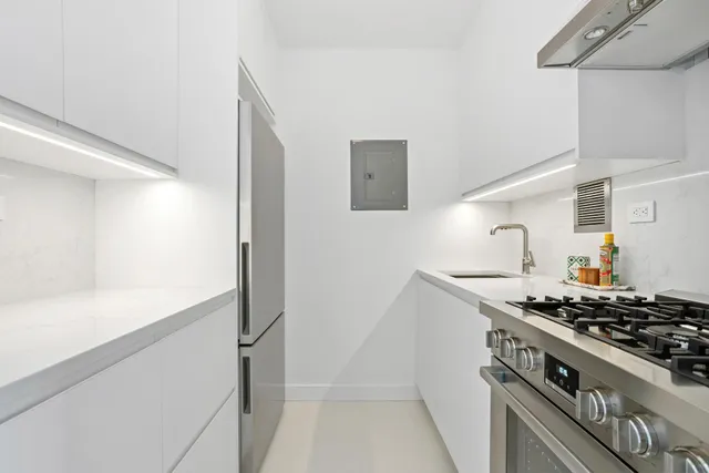 a living room with furniture a window and a flat screen tv