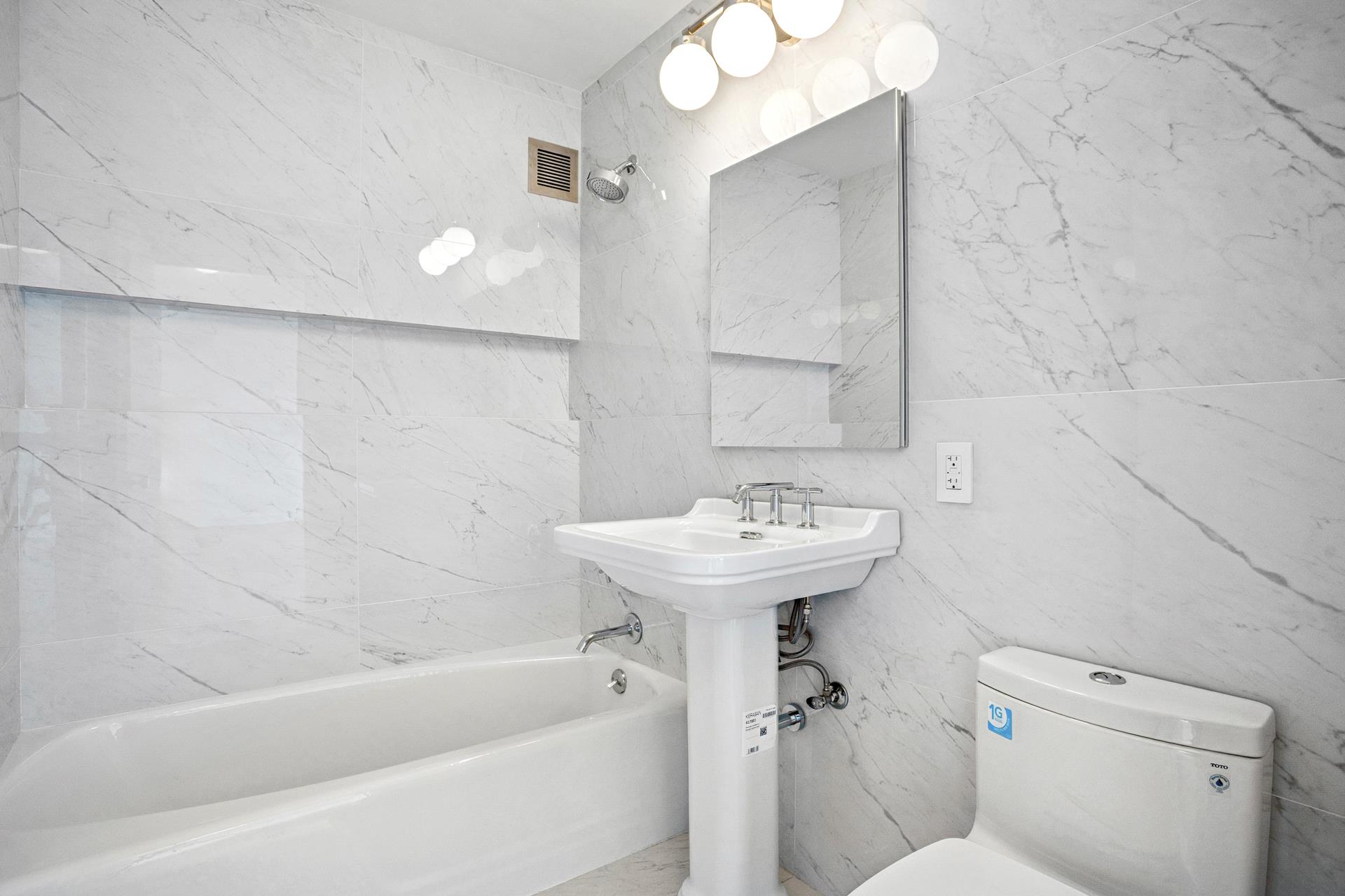 45 West 67th Street, Unit 25F Manhattan, NY 10023 - Photo 5 of 9 a bathroom with a sink a toilet and bathtub