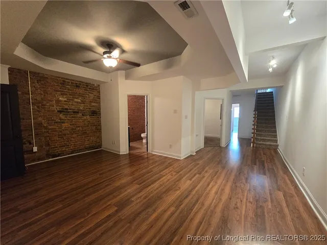 a view of hallway with wooden floor