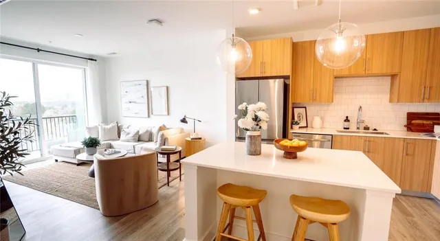 a dining room with stainless steel appliances a table a table and chairs