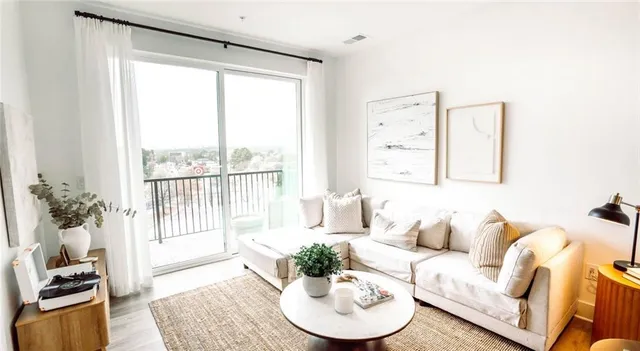a living room with furniture and a potted plant