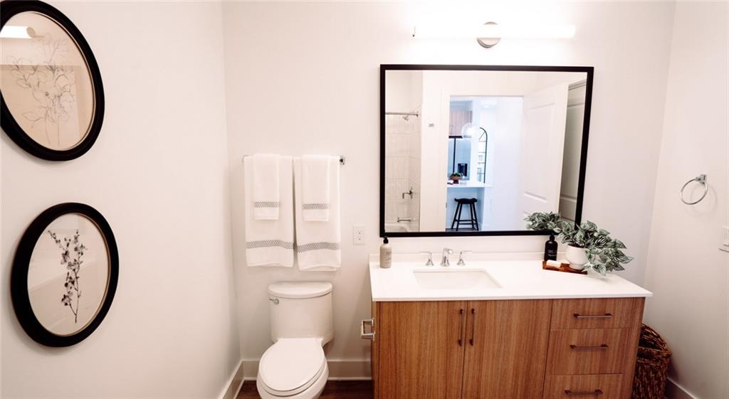 2490 North Druid Hills Road Atlanta, GA 30329 - Photo 7 of 18 a bathroom with a toilet a sink and a mirror