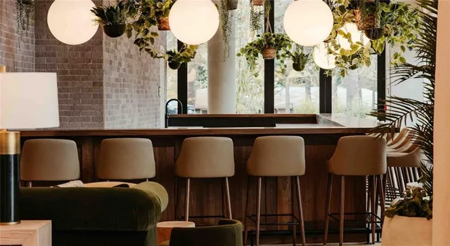 a kitchen with a table chairs and a chandelier