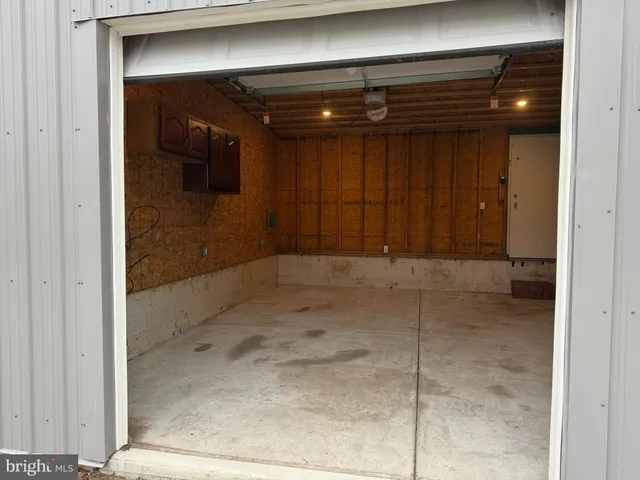 a living room with a fireplace furniture and a ceiling fan