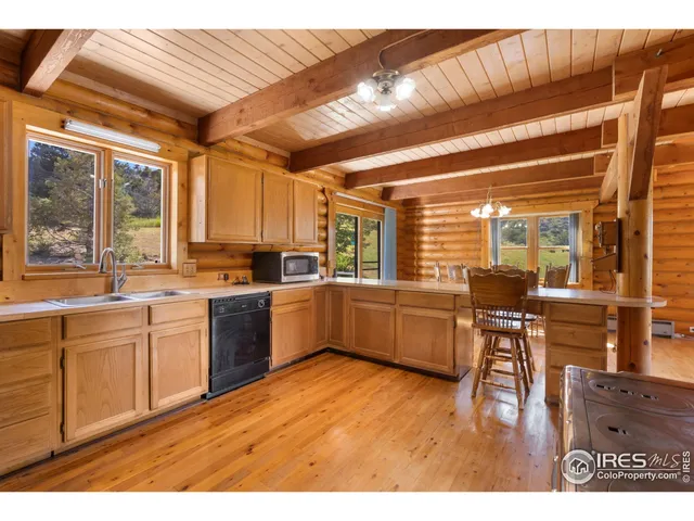 a dining room with stainless steel appliances kitchen island granite countertop a table and chairs