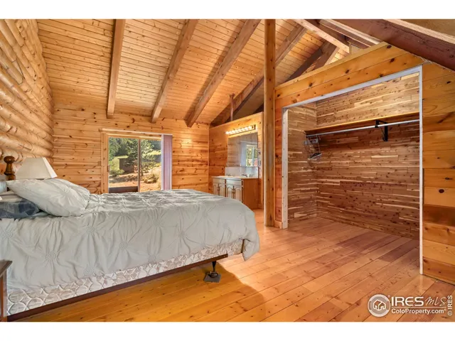 a living room with a bed furniture and a flat screen tv