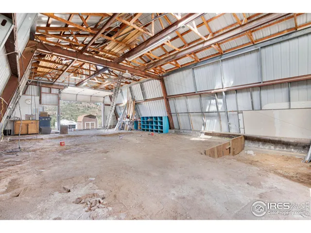 a open kitchen with stainless steel appliances kitchen island granite countertop a refrigerator a stove and a microwave