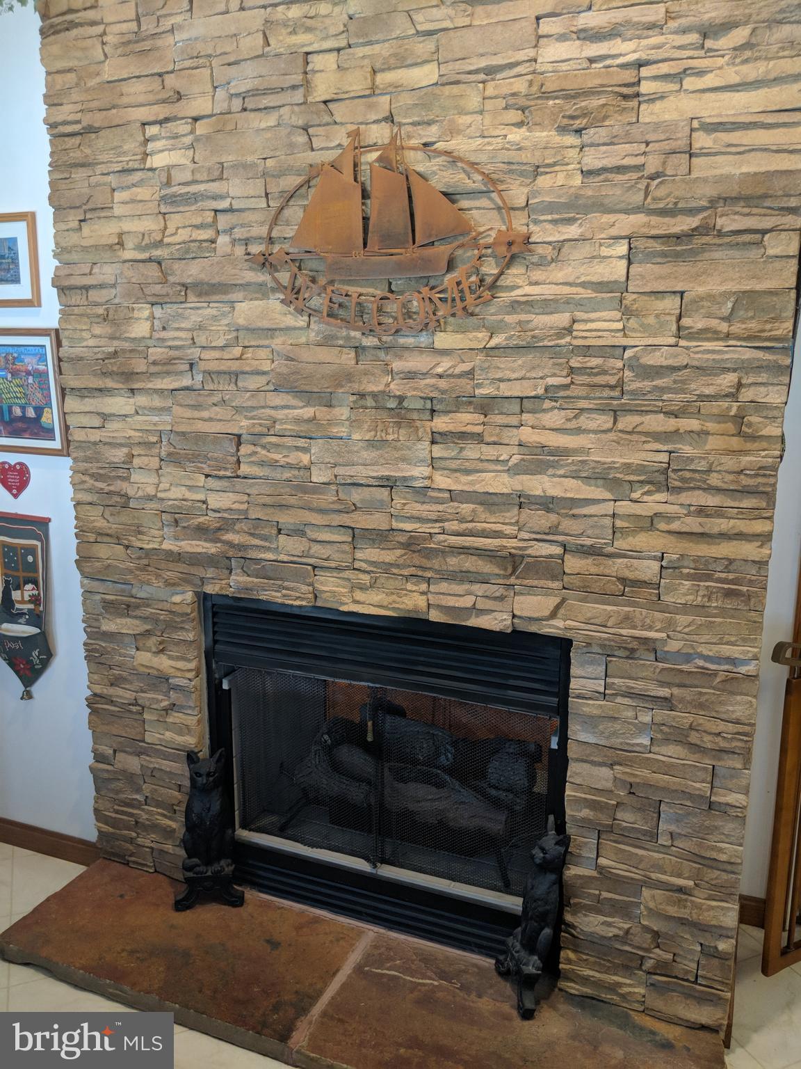 206 Ackerman Road Stevensville, MD 21666 - Photo 22 of 27 Two sided fireplace (kitchen side)