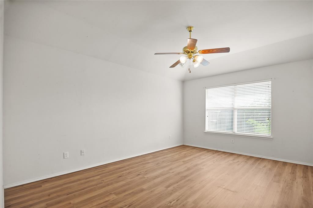 3041 Winding Meadow Trail Princeton, TX 75407 - Photo 13 of 20 wooden floor in an empty room with a window
