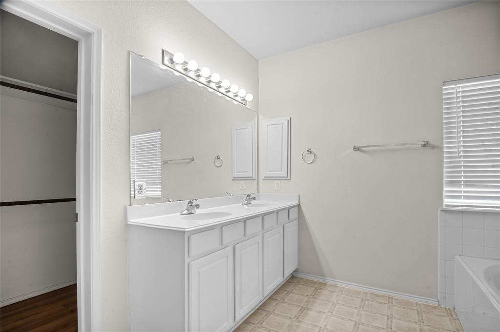 3041 Winding Meadow Trail Princeton, TX 75407 - Photo 14 of 20 a bathroom with a sink and a mirror