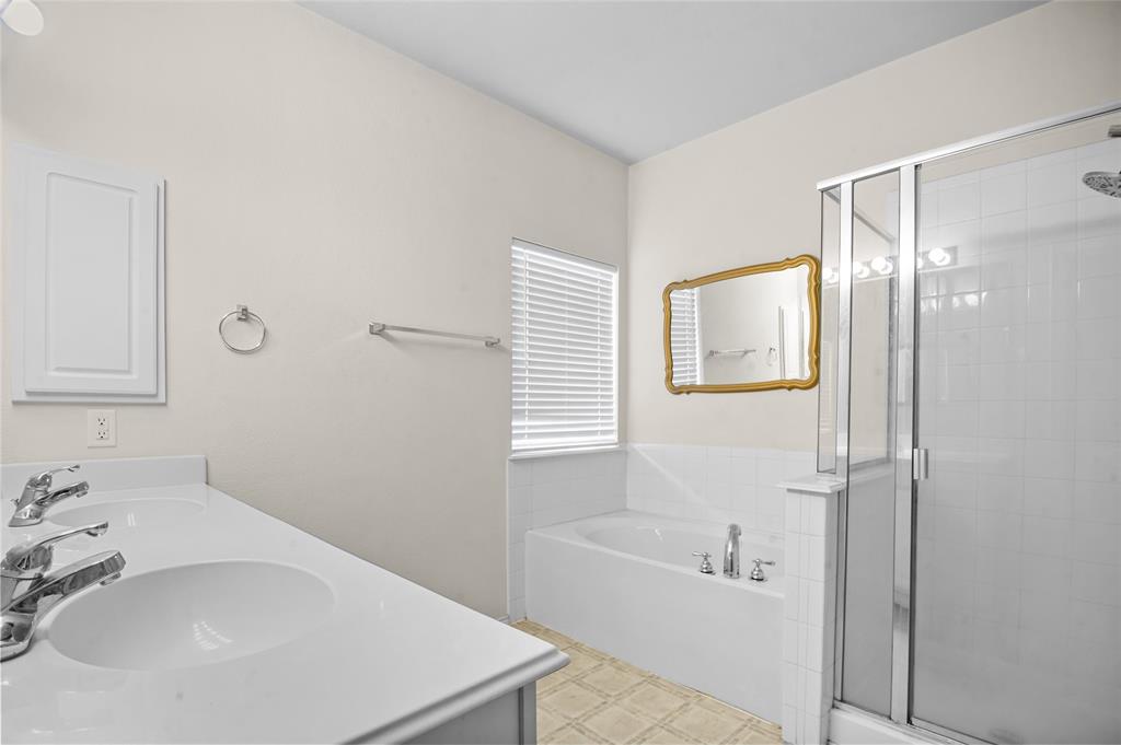 3041 Winding Meadow Trail Princeton, TX 75407 - Photo 15 of 20 a bathroom with a bathtub and a sink