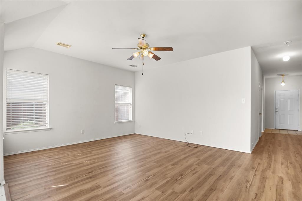 3041 Winding Meadow Trail Princeton, TX 75407 - Photo 4 of 20 wooden floor in an empty room with a window