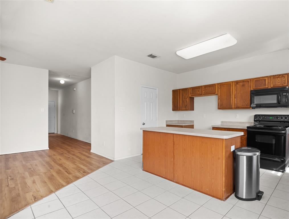 3041 Winding Meadow Trail Princeton, TX 75407 - Photo 6 of 20 a kitchen with stainless steel appliances granite countertop a refrigerator and a stove top oven