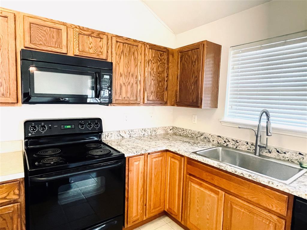 3041 Winding Meadow Trail Princeton, TX 75407 - Photo 8 of 20 a kitchen with granite countertop stove top oven and cabinets
