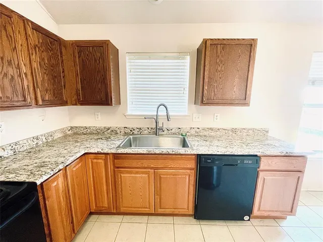 a kitchen with a sink and a wooden cabinets