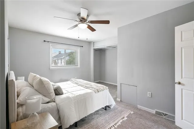 a bedroom with a large bed and a window